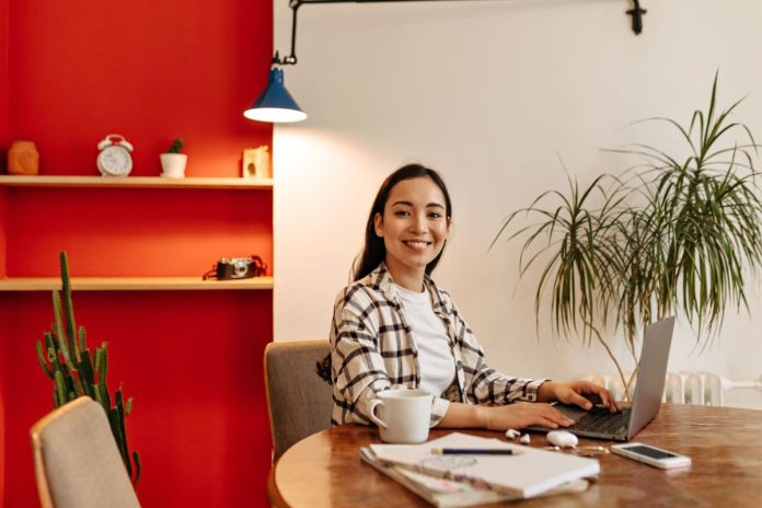 business-lady-in-plaid-jacket-sitting-at-desk self evaluation at work